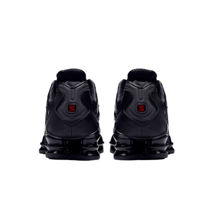 Black sneakers with red accents on a white background